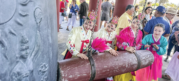 Kim Eung Hwa Korean Dance Company members ring the Korean Friendship Bell on Independence Day